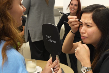 Aesthetic professional marking a client's forehead during a facial assessment